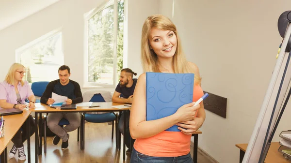 Student girl in front of her mates in classroom — Stock Photo, Image