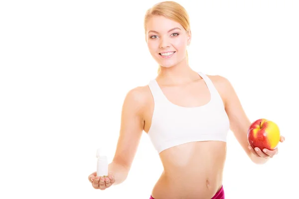 Mulher segurando vitaminas e maçã. Serviços de saúde. — Fotografia de Stock