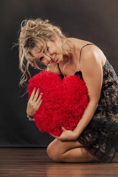 Mature woman hug big red heart — Stock Photo, Image