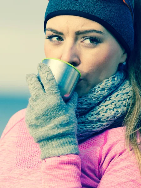 Подходящая женщина в холодный день согревается чаем — стоковое фото
