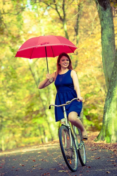 Wspaniała dziewczyna jazda na rowerze z parasolem. — Zdjęcie stockowe
