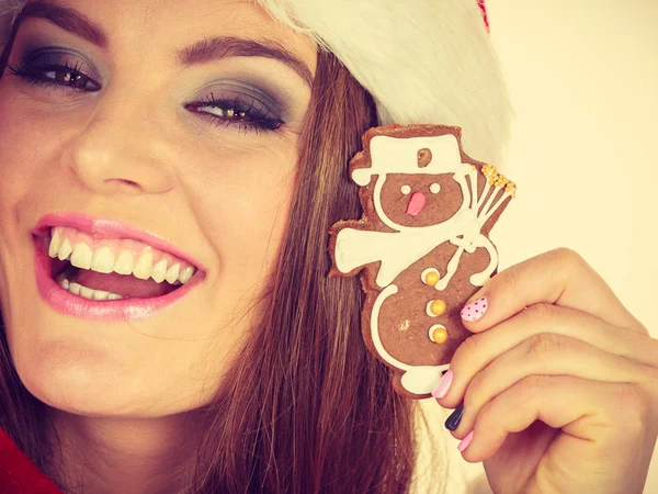 Woman santa claus hat with gingerbread cookie. Christmas — Stock Photo, Image