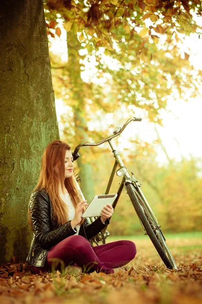 Young lady is looking at her tablet. — Stock Photo, Image