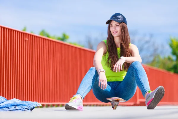 Teenage girl skater riding skateboard on street. — Stock Photo, Image