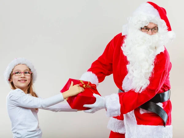 Santa Claus fighting with girl for present — Stock Photo, Image