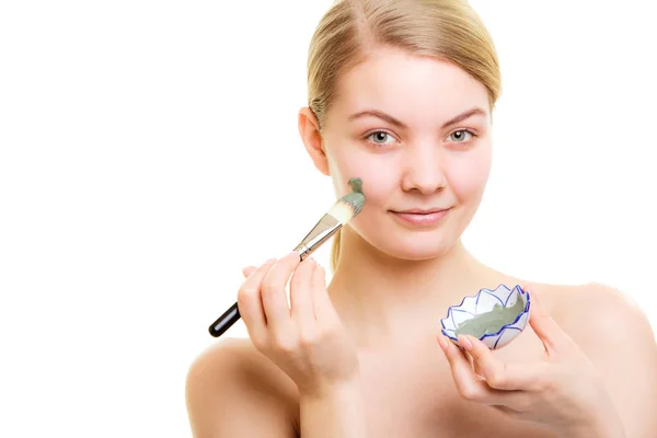 Skin care. Woman applying clay mud mask on face. — Stock Photo, Image