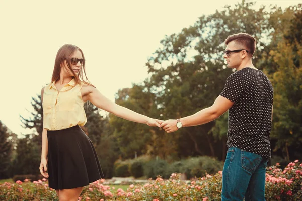 Cheerful girl holding hands in park. — Stock Photo, Image