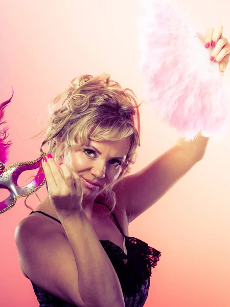 Woman holding carnival mask feather fan in hand — Stock Photo, Image