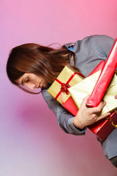 Guy with many presents gift boxes — Stock Photo, Image