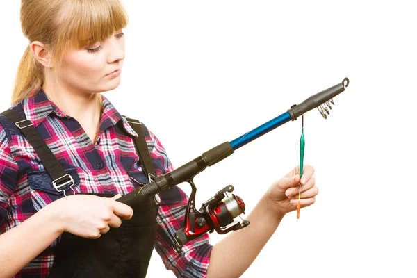 Woman in shirt looking at fishing rod — Stock Photo, Image