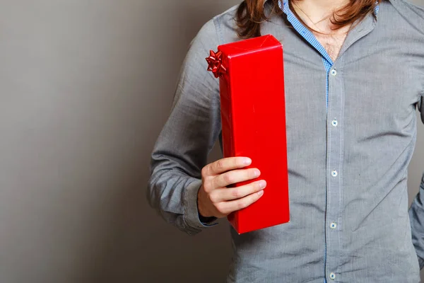 Guy holding present red gift box — Stock Photo, Image