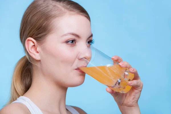 Kvinna som dricker apelsin smaksatt dryck eller juice — Stockfoto