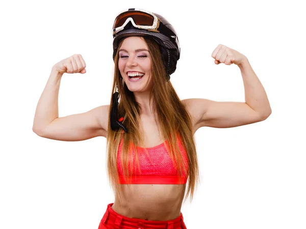 Woman wearing ski suit, helmet with goggles showing muscles — Stock Photo, Image