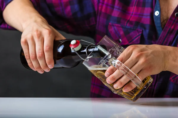 Tapster fills stein from bottle. — Stock Photo, Image