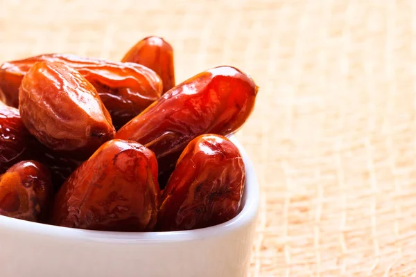 Dried dates in bowl on table background — Stock Photo, Image