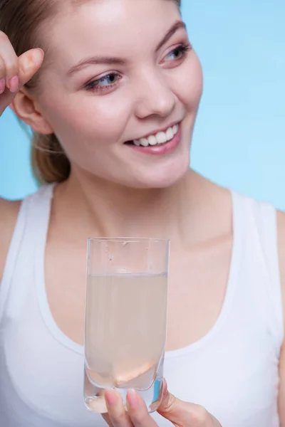 Wanita memegang kaca dengan air dan tablet effervescent — Stok Foto