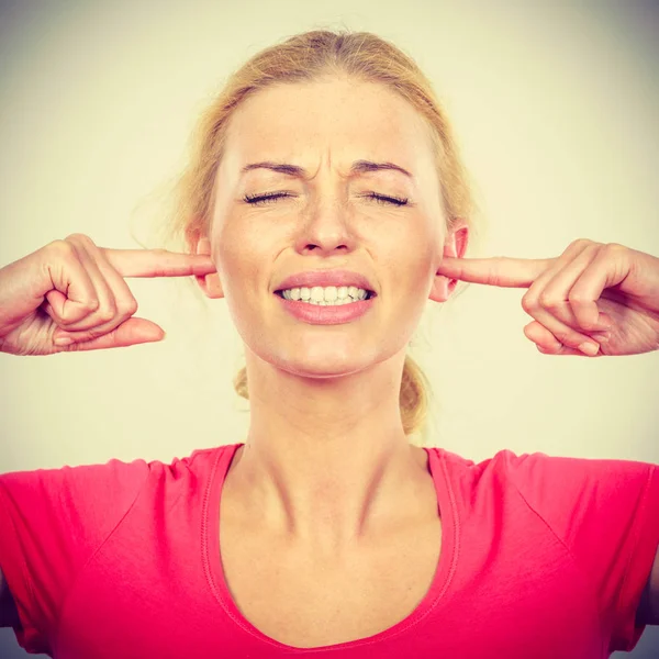 Woman closing ears with fingers, big noise. — Stock Photo, Image