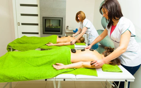 Massage with hot rocks stones in beautician — Stock Photo, Image