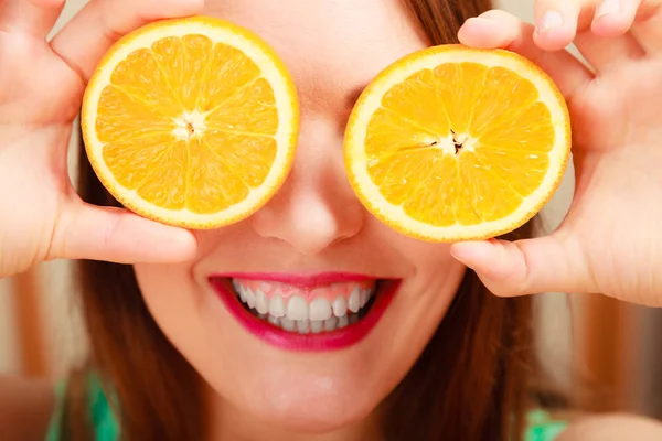 Mulher cobrindo os olhos com laranja . — Fotografia de Stock