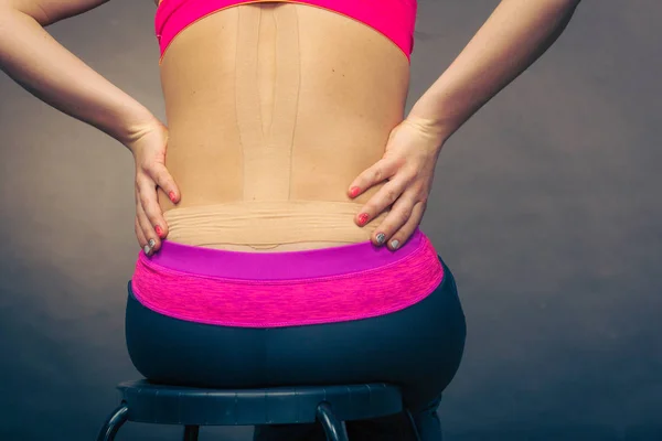 Woman with medical kinesio taping on back — Stock Photo, Image