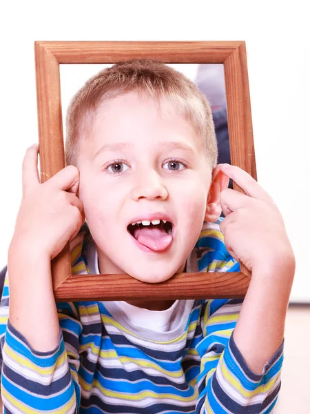 Kleine jongen spelen met leeg frame. — Stockfoto