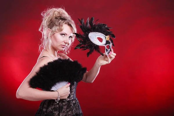 Woman holding carnival mask feather fan in hand — Stock Photo, Image