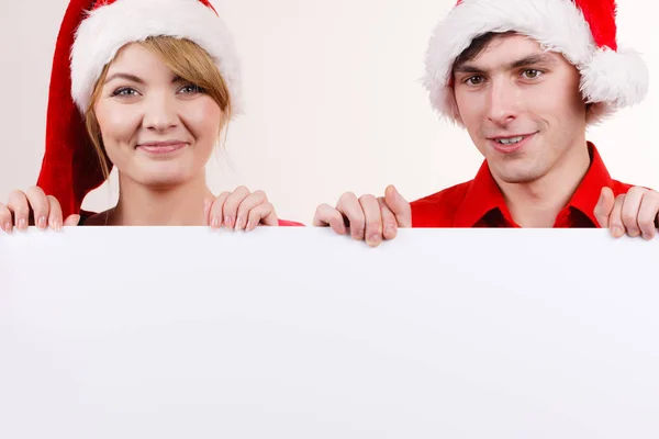 Couple with blank empty banner board. Christmas Royalty Free Stock Images
