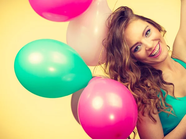 Woman holding bunch of colorful balloons — Stock Photo, Image