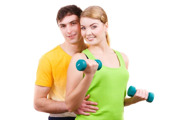 Couple exercising with dumbbells lifting weights Stock Picture