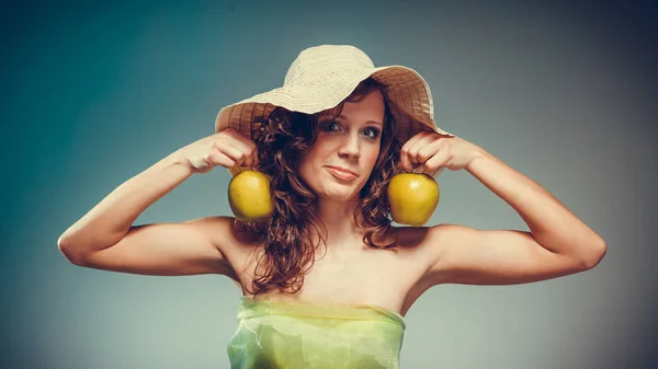 Kvinna i klänning och hatt hålla gula äpple — Stockfoto
