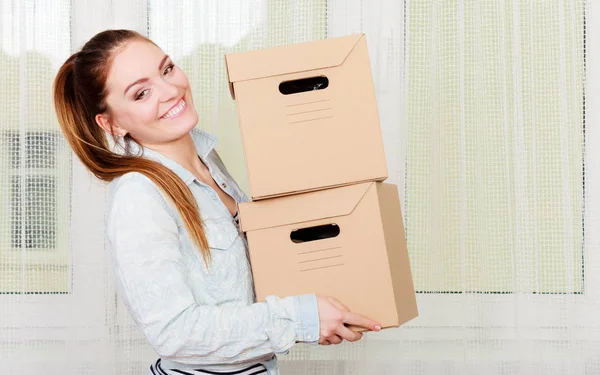 Happy woman moving into house carrying boxes. — Stock Photo, Image