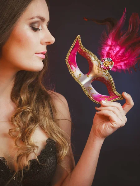 Sensual lady holding carnival mask. — Stock Photo, Image