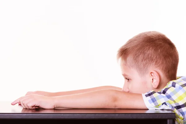 Bored little boy sit alone at table. — Stock Photo, Image