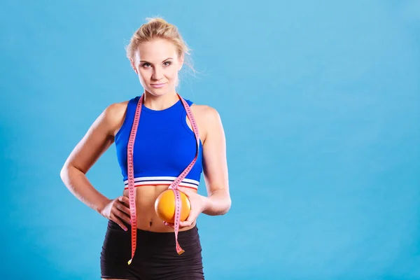Woman fit girl with measure tape and grapefruit — Stock Photo, Image