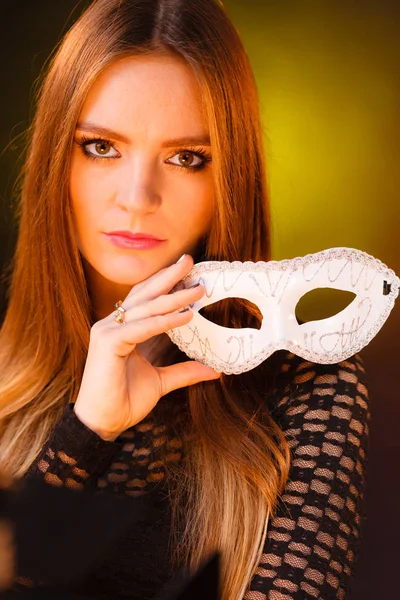 Sensual lady holding carnival mask. — Stock Photo, Image