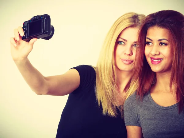 Two models girls taking self picture with camera — Stock Photo, Image