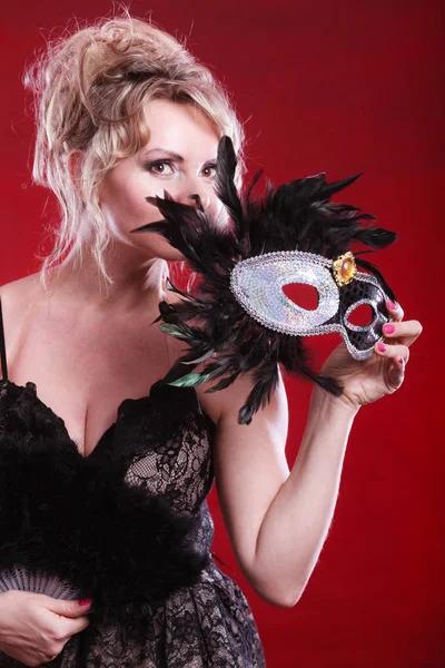 Woman holding carnival mask feather fan in hand — Stock Photo, Image