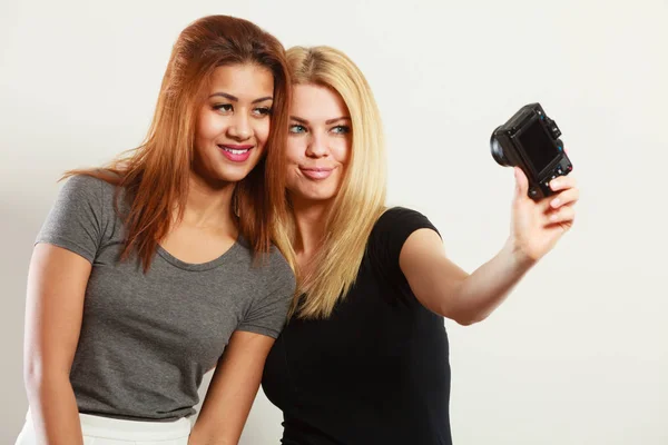 Two models girls taking self picture with camera — Stock Photo, Image