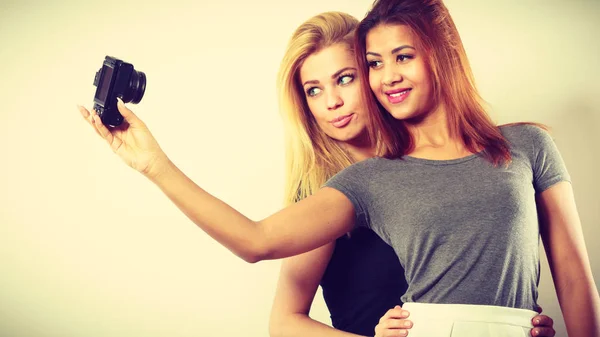 Two models girls taking self picture with camera — Stock Photo, Image