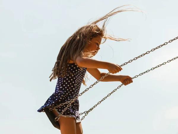 Girl swinging on swing-set. — Stock Photo, Image