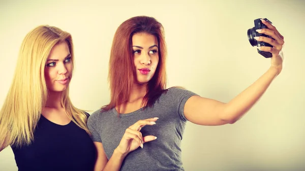 Two models girls taking self picture with camera — Stock Photo, Image