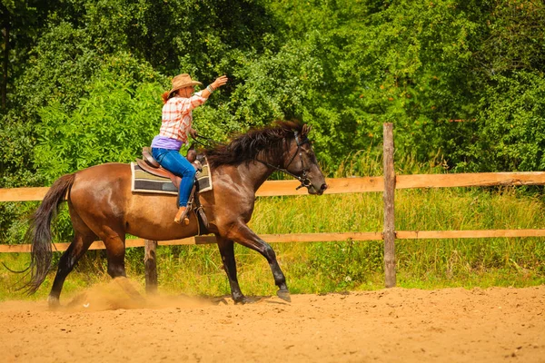 Cowgirl gör häst ridning på landsbygden äng — Stockfoto