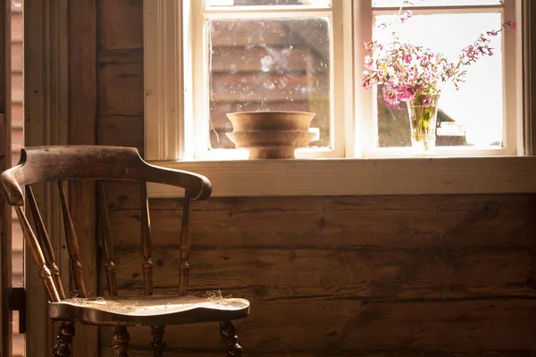 Vintage wooden chair, old cottage next to window — Stock Photo, Image