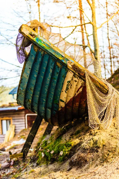 Old, dirty piece of boat covered in net — Stock Photo, Image