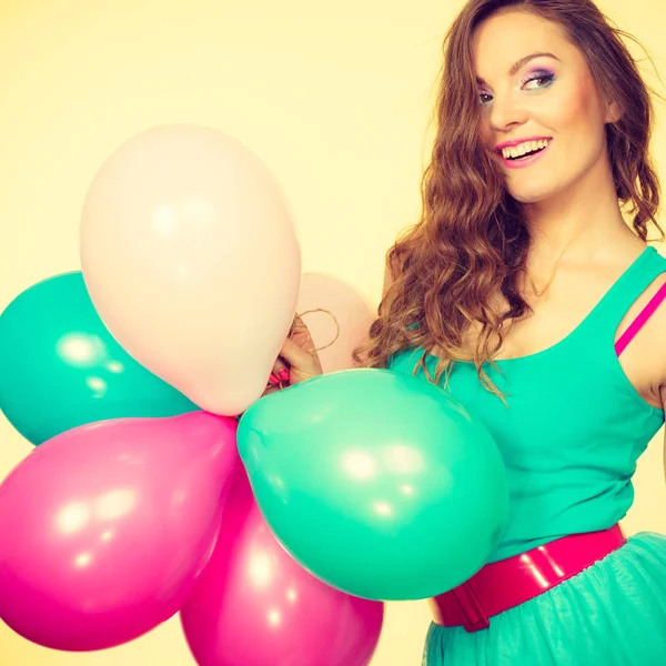 Woman holding bunch of colorful balloons — Stock Photo, Image