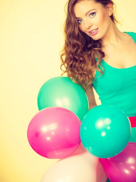 Woman holding bunch of colorful balloons — Stock Photo, Image