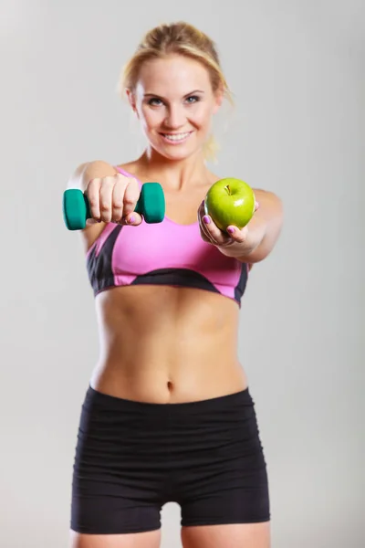 Diet fit body. Girl holds dumbbells and apple fruit — Stock Photo, Image