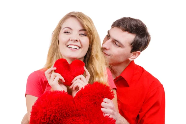Couple holds red heart shaped pillows love symbol — Stock Photo, Image