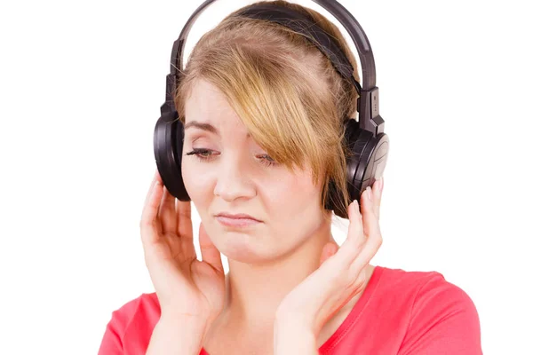 Woman sad girl in big headphones listening music — Stock Photo, Image