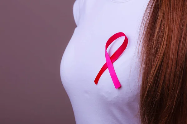 Pink ribbon on woman chest to support breast cancer cause — Stock Photo, Image